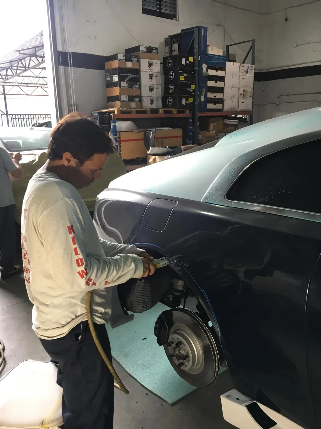 Technician working on a Rolls-Royce wheel and brake